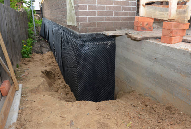 Happy homeowners after waterproofing job in Eva